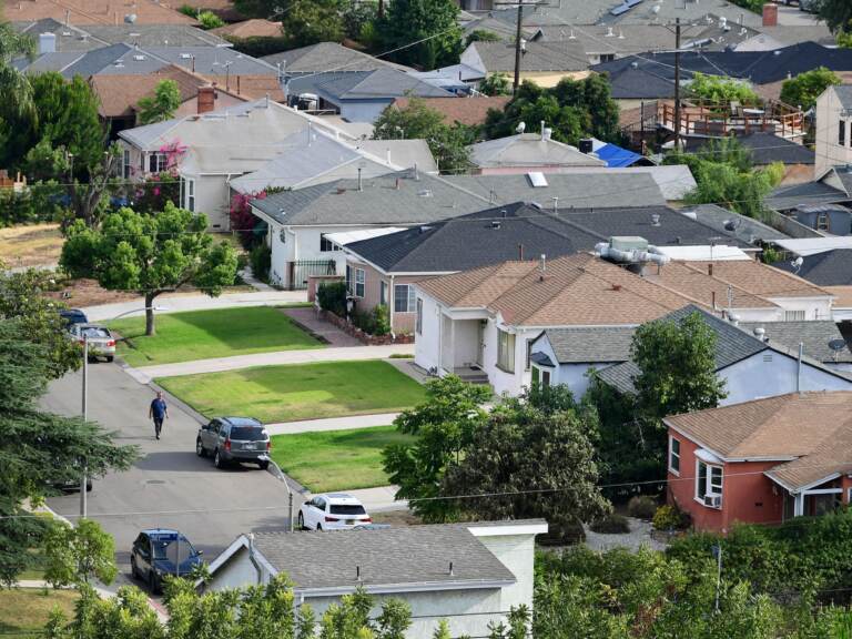 A man walks through a neighborhood of single-family homes in Los Angeles last week. The CDC announced a new temporary eviction ban a few days after the previous one expired. (Frederic J. Brown/AFP via Getty Images)