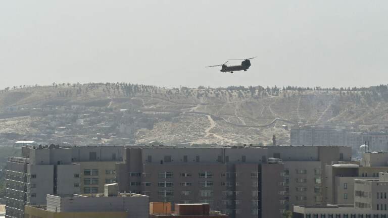 A U.S. military helicopter is pictured flying above the U.S. Embassy in Kabul