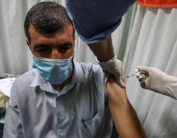 A medic administers a dose of the Pfizer-BioNTech COVID-19 vaccine