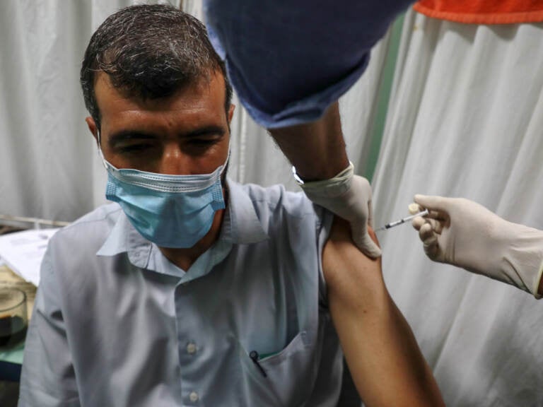 A medic administers a dose of the Pfizer-BioNTech COVID-19 vaccine
