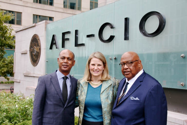 AFL-CIO officers (from left) Tefere Gebre, Liz Shuler and Fred Redmond stand in front of the federation's headquarters