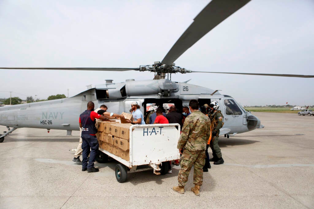 A U.S. Navy helicopter unit, USAID and other support groups prepare to deliver humanitarian aid