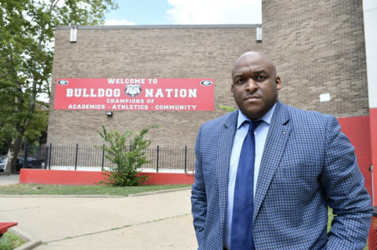 Leyondo Dunn stands outside Gratz high school