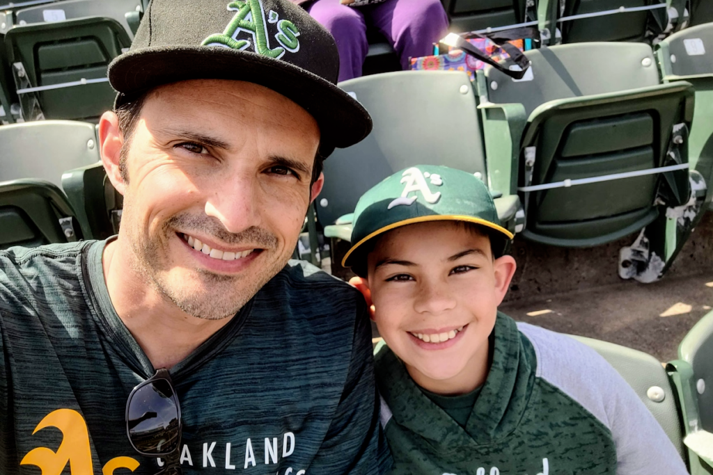 A father and son at a baseball game.