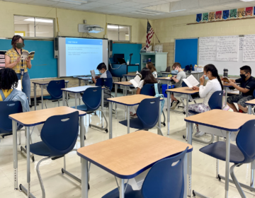 Students read a book inside a Delaware classroom