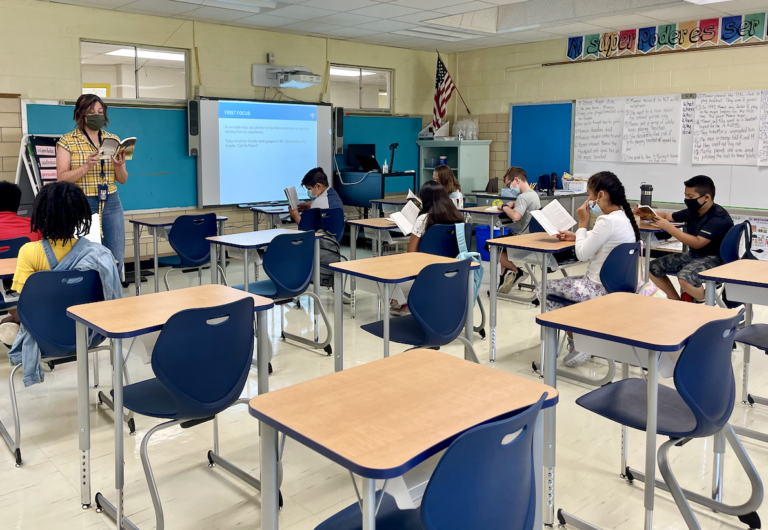 Students read a book inside a Delaware classroom