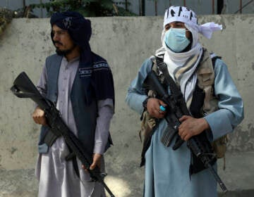 Taliban fighters stand guard in the main gate leading to Afghan presidential palace, in Kabul, Afghanistan, Monday, Aug. 16, 2021. The U.S. military has taken over Afghanistan’s airspace as it struggles to manage a chaotic evacuation after the Taliban rolled into the capital. (AP Photo/Rahmat Gul)