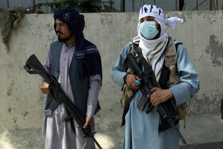 Taliban fighters stand guard in the main gate leading to Afghan presidential palace, in Kabul, Afghanistan, Monday, Aug. 16, 2021. The U.S. military has taken over Afghanistan’s airspace as it struggles to manage a chaotic evacuation after the Taliban rolled into the capital. (AP Photo/Rahmat Gul)