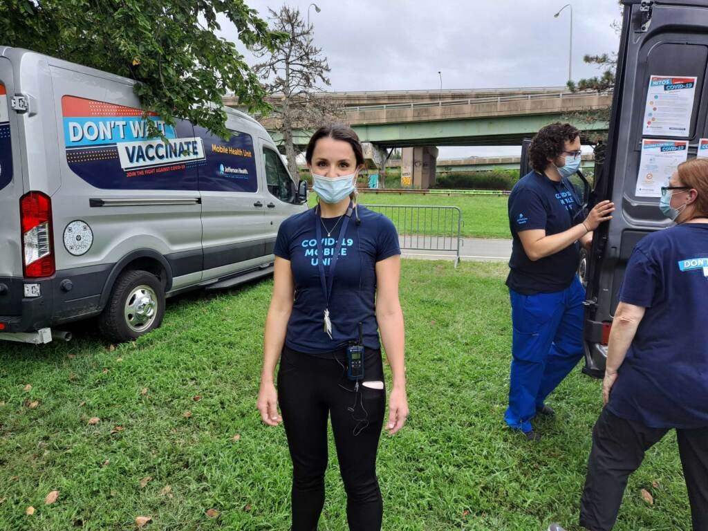 Morgan Hutchinson stands outside while wearing a mask