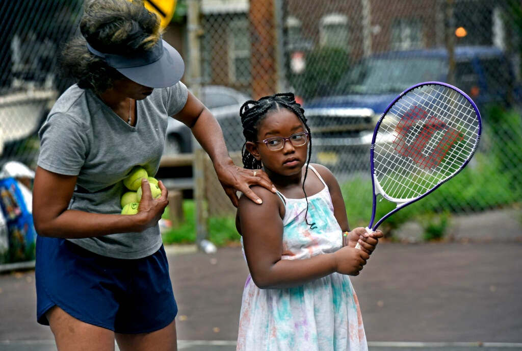 Kelly Cass-White gives pointers to Jeyla Long, 7, in Camden on Aug. 26, 2021