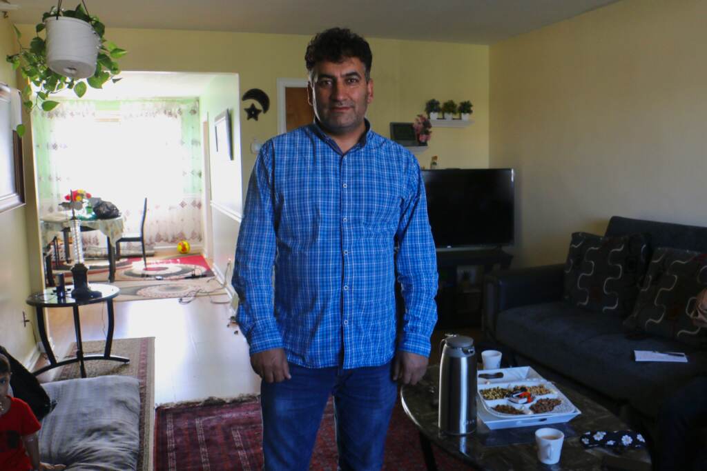 Mohammed Sadeed stands inside his living room