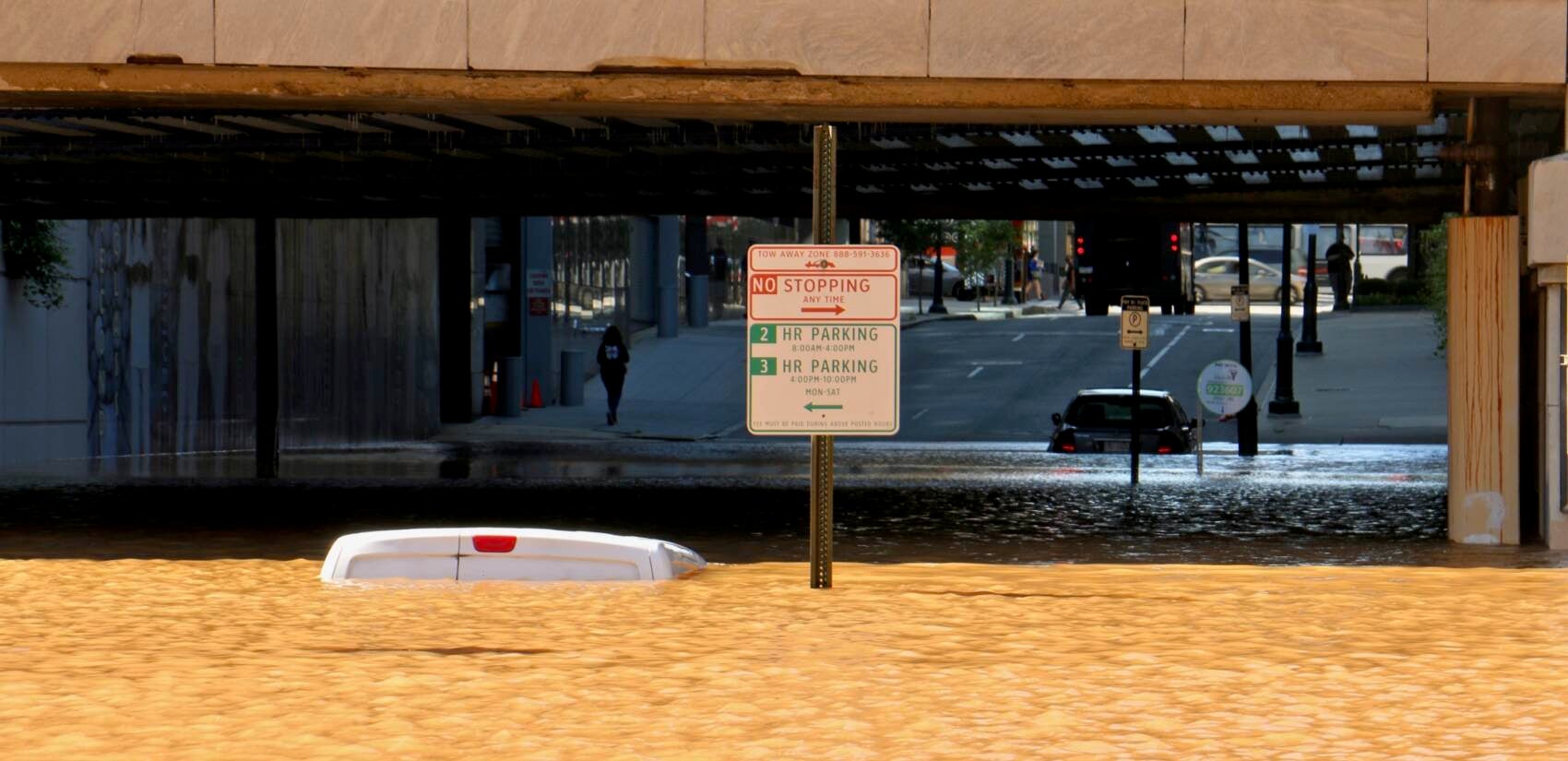 Vehicle is submerged in floodwater under the JFK Boulevard