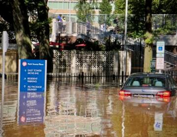 Vehicle is submerged in floodwater in Center City