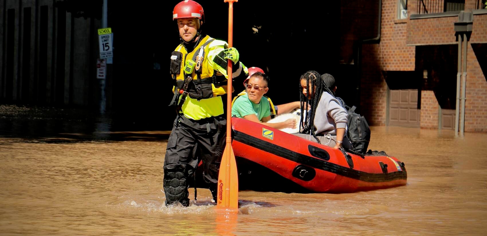 Fire Department rescue teams assist residents via raft