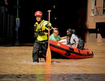 Fire Department rescue teams assist residents via raft