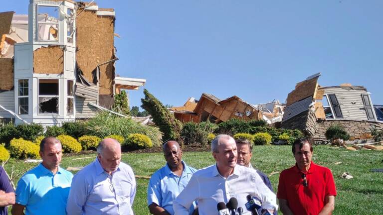 Gov. Phil Murphy stands with officials