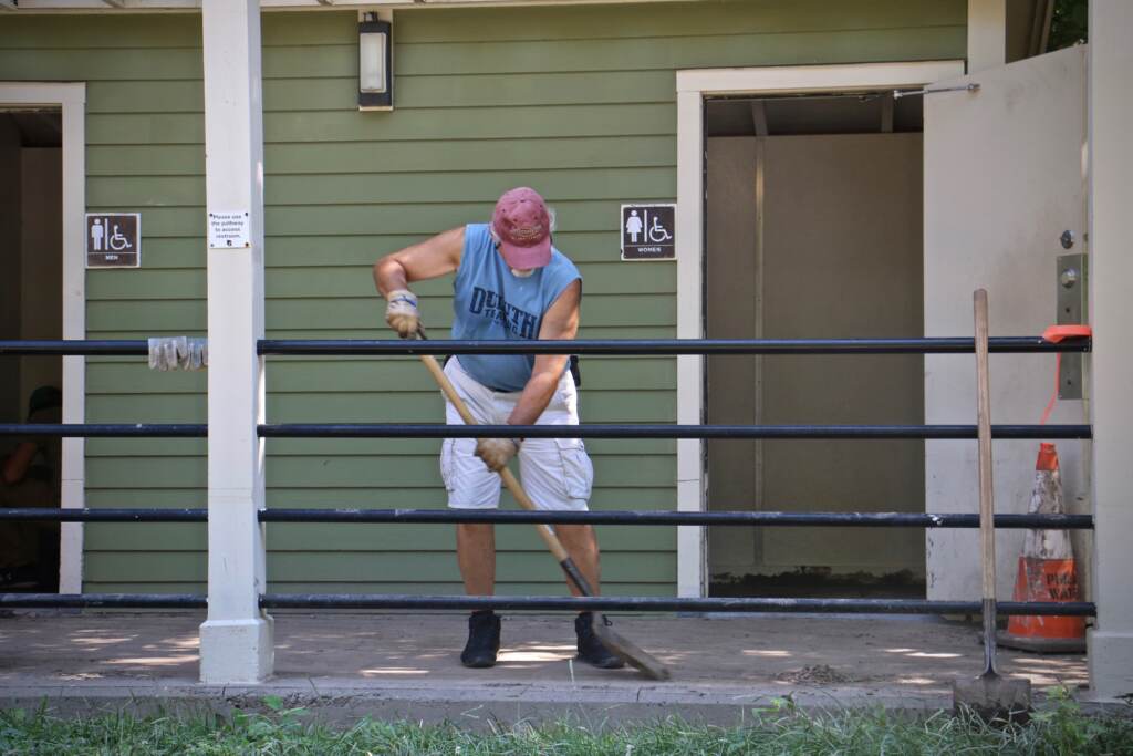 Schuylkill Banks volunteer Elit Felix helps clean the restrooms along the Schuylkill River Trail