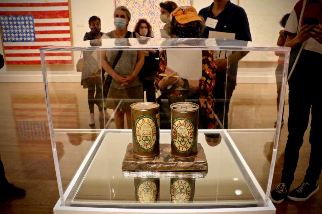 ''Painted Bronze'' (1960) presents two seemingly identical but subtly different representations of Ballantine Ale cans, reflecting Jasper Johns' interest in duplication and mirroring