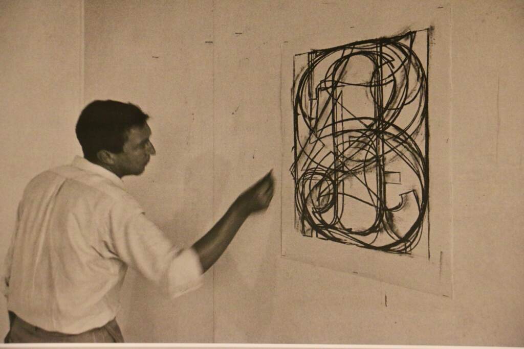 A photograph by Ugo Mulas shows Jasper Johns working on ''0 through 9'' in 1965