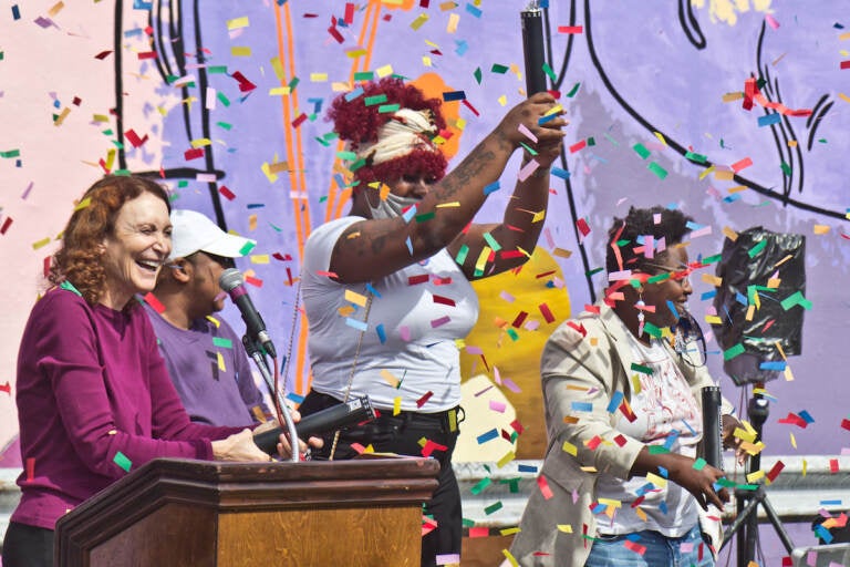 Mural Arts’ executive director, Jane Golden (left), with mural models Tazmere Stephens (second from left) and Jourdyn Wood (second from right) and artist Kah Tangi, celebrate the dedication of We Are Universal to Philadelphia’s trans community