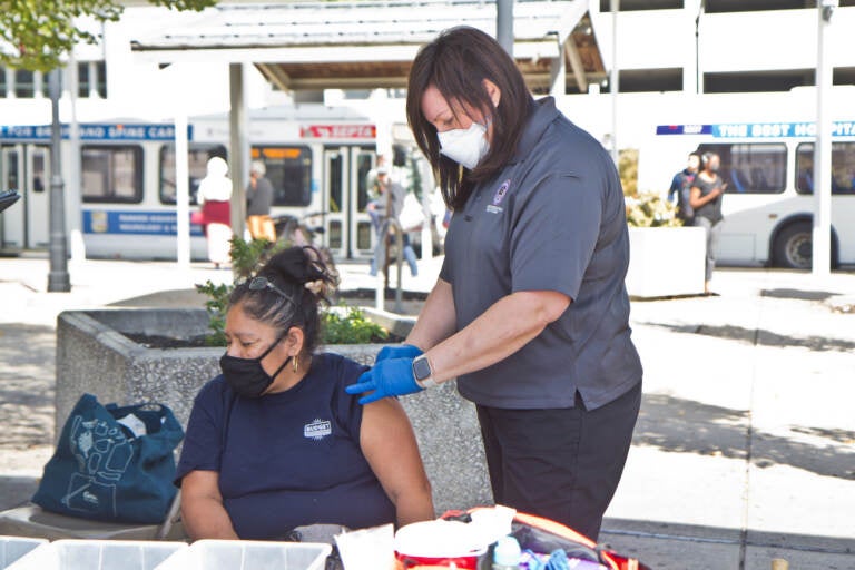 A woman receives the COVID-19 vaccine at Montgomery County Department of Safety’s mobile health vaccination site on September 29, 2021. (Kimberly Paynter/WHYY)