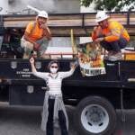 Charito Calvachi-Mateyko, who participated in Tuesday’s march in Washington, posed with two unidentified workers that day