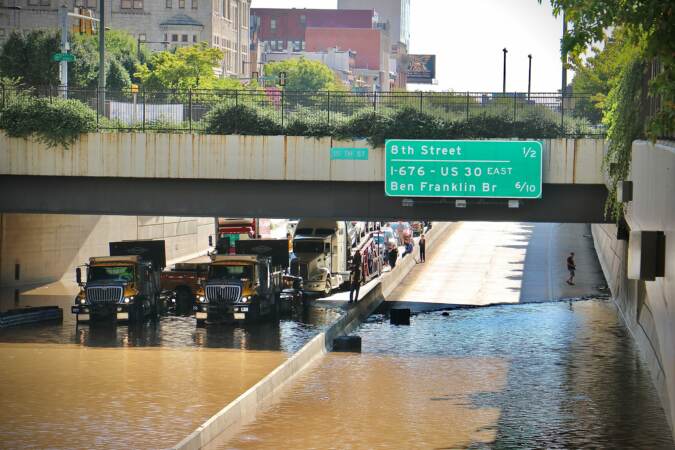 Flooding closes the Vine Street Expressway from Broad Street to the Schuylkill River.