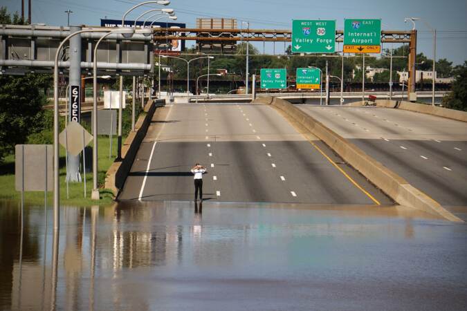 Flooding closes the Vine Street Expressway from Broad Street to the Schuylkill River.