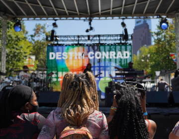 A band rehearses in front of a few early arrivals at the 2021 Made in America festival