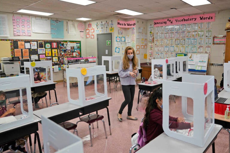 Maria Mirkovic works with some of her third graders in her classroom