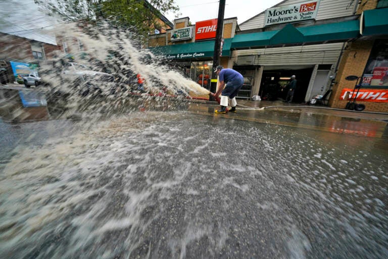 Water is pumped from the basement of a business on Noblestown road in Oakdale, Pa. during clean up from flooding after downpours and high winds from the remnants of Hurricane Ida, hit the area Wednesday, Sept. 1, 2021