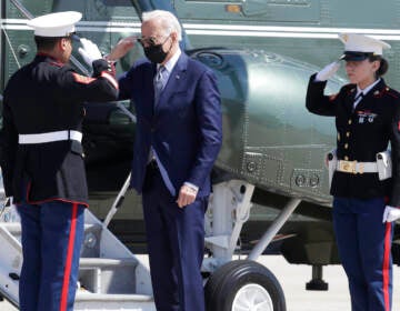 President Joe Biden returns a salute with a Marine Corp honor guard as he disembarks Marine One before boarding Air Force One