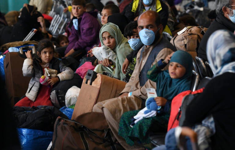 Afghan refugees are processed inside Hangar 5 at the Ramstein U.S. Air Base in Germany