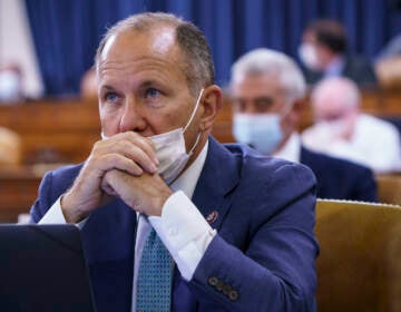 Rep. Lloyd Smucker sits with his mask below his nose at a House hearing