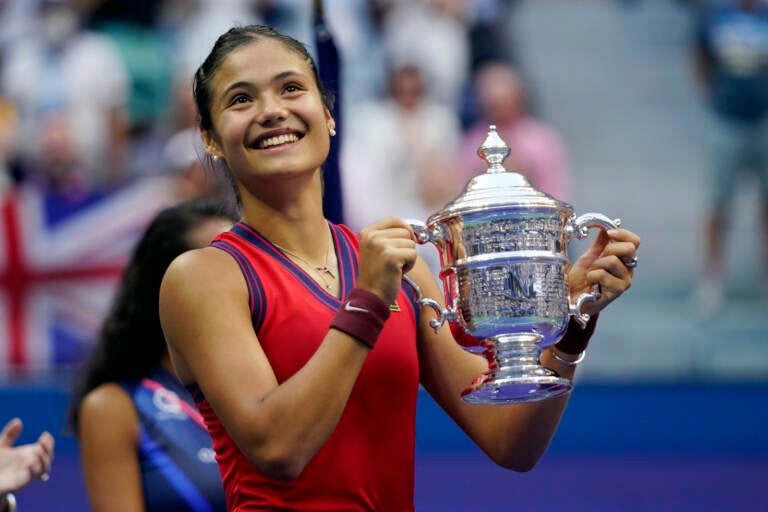 Emma Raducanu, of Britain, holds up the US Open championship trophy after defeating Leylah Fernandez, of Canada, during the women’s singles final of the US Open tennis championships, Saturday, Sept. 11, 2021, in New York