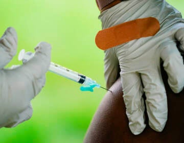 A health worker administers a dose of a Pfizer COVID-19 vaccine during a vaccination clinic at the Reading Area Community College in Reading, Pa., Tuesday, Sept. 14, 2021. (AP Photo/Matt Rourke)