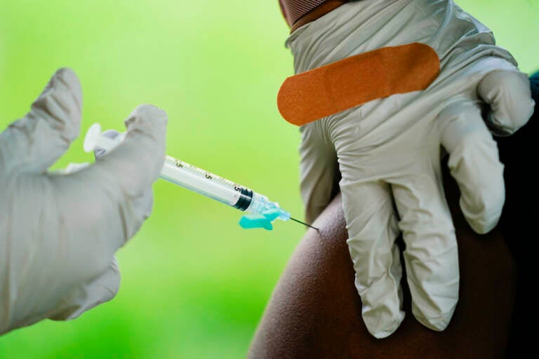 A health worker administers a dose of a Pfizer COVID-19 vaccine during a vaccination clinic at the Reading Area Community College in Reading, Pa., Tuesday, Sept. 14, 2021. (AP Photo/Matt Rourke)