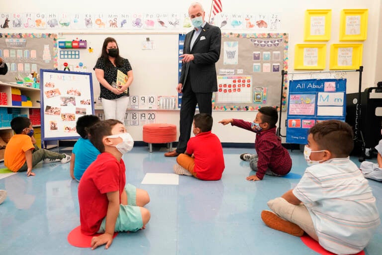 New Jersey Gov. Phil Murphy talks to three and four year old students in a pre-K class at the Dr. Charles Smith Early Childhood Center, Thursday, Sept. 16, 2021, in Palisades Park, N.J. Murphy toured the school before announcing plans to plans to provide universal pre-K for all families in New Jersey. (AP Photo/Mary Altaffer)