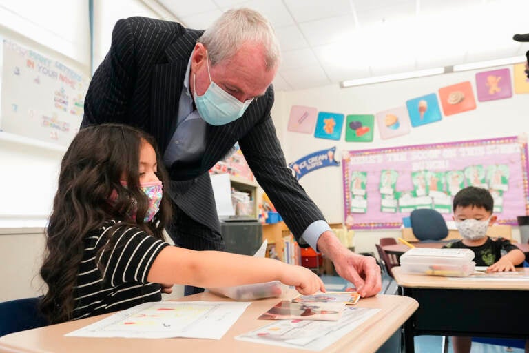 Gov. Phil Murphy looks at a drawing a student has done.