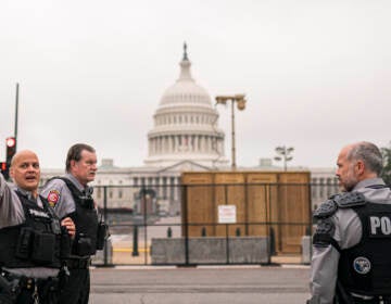 Police stand outside a security fence ahead of a rally near the U.S. Capitol in Washington, Saturday, Sept. 18, 2021. The rally was planned by allies of former President Donald Trump and aimed at supporting the so-called 