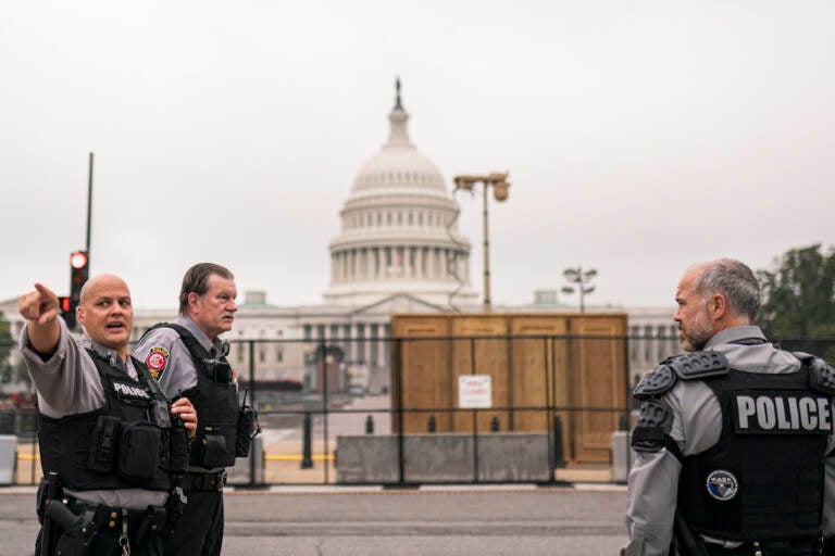 Police stand outside a security fence ahead of a rally near the U.S. Capitol in Washington, Saturday, Sept. 18, 2021. The rally was planned by allies of former President Donald Trump and aimed at supporting the so-called 