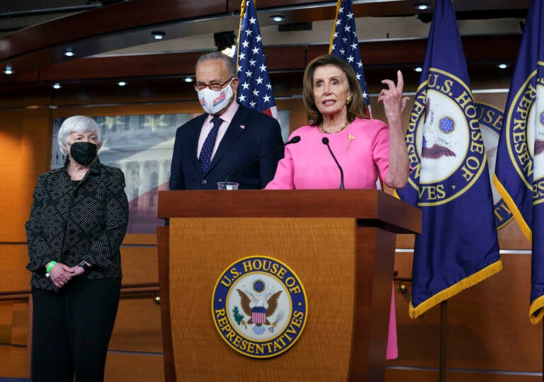 Nancy Pelosi, Chuck Schumer, and Janet Yellen surround a podium