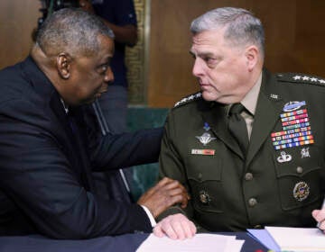 Secretary of Defense Lloyd Austin, left, and Chairman of the Joint Chiefs Chairman Gen. Mark Milley talk before a Senate Appropriations Committee hearing