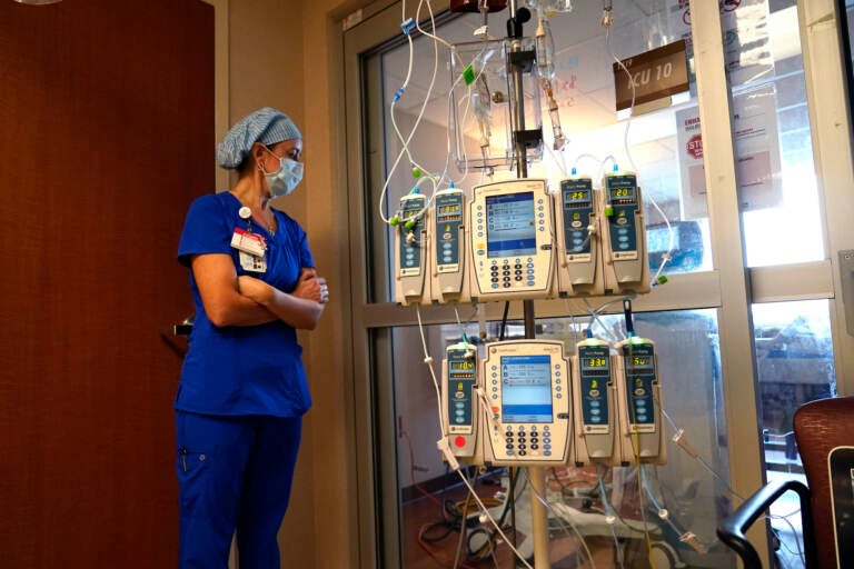 Beth Springer looks into a patient's room in a COVID-19 ward