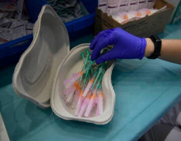 A health worker prepares Pfizer vaccines