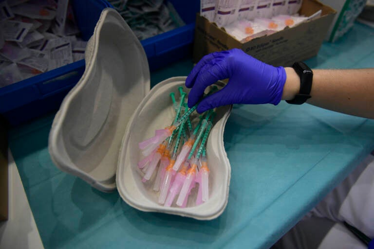 A health worker prepares Pfizer vaccines