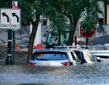 Cars are seen in a flooded area of Philly