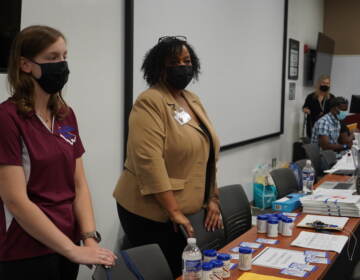 County agencies and partners set up tables along the inside of the center to assist those in need. (Kenny Cooper / WHYY)