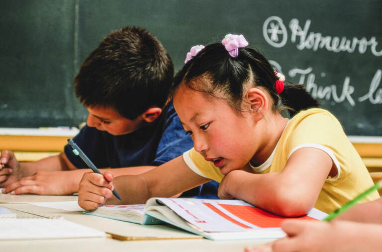 A young girl and young boy in school