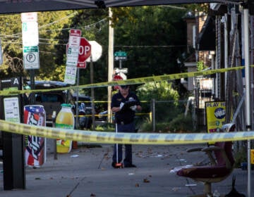 A crime scene investigator works on the scene of a mass shooting